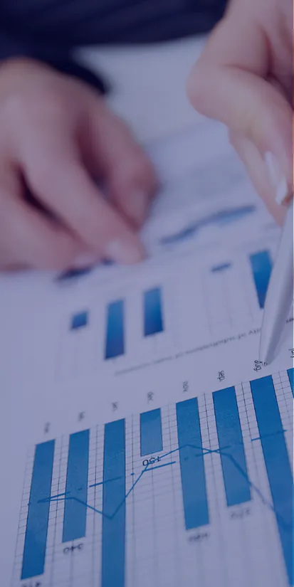 a pair of hands hover over a report showing graphs and data