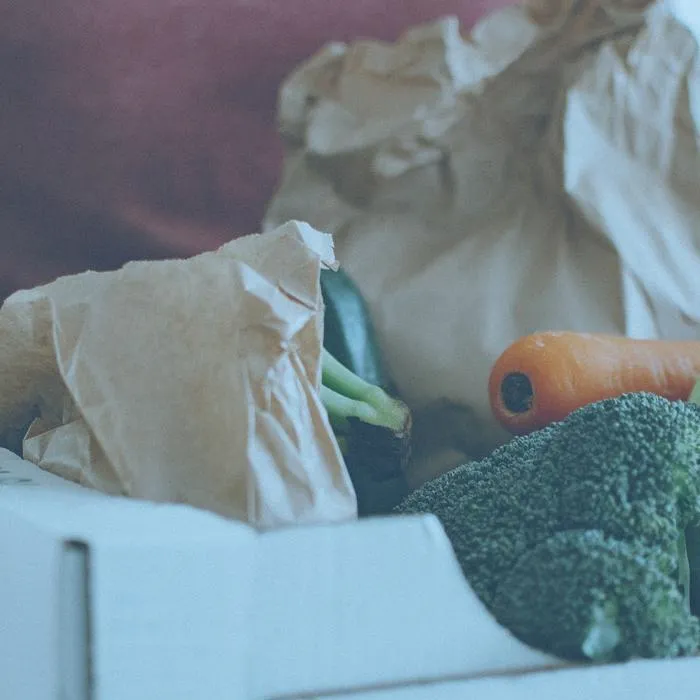 Man holding a box of vegetables