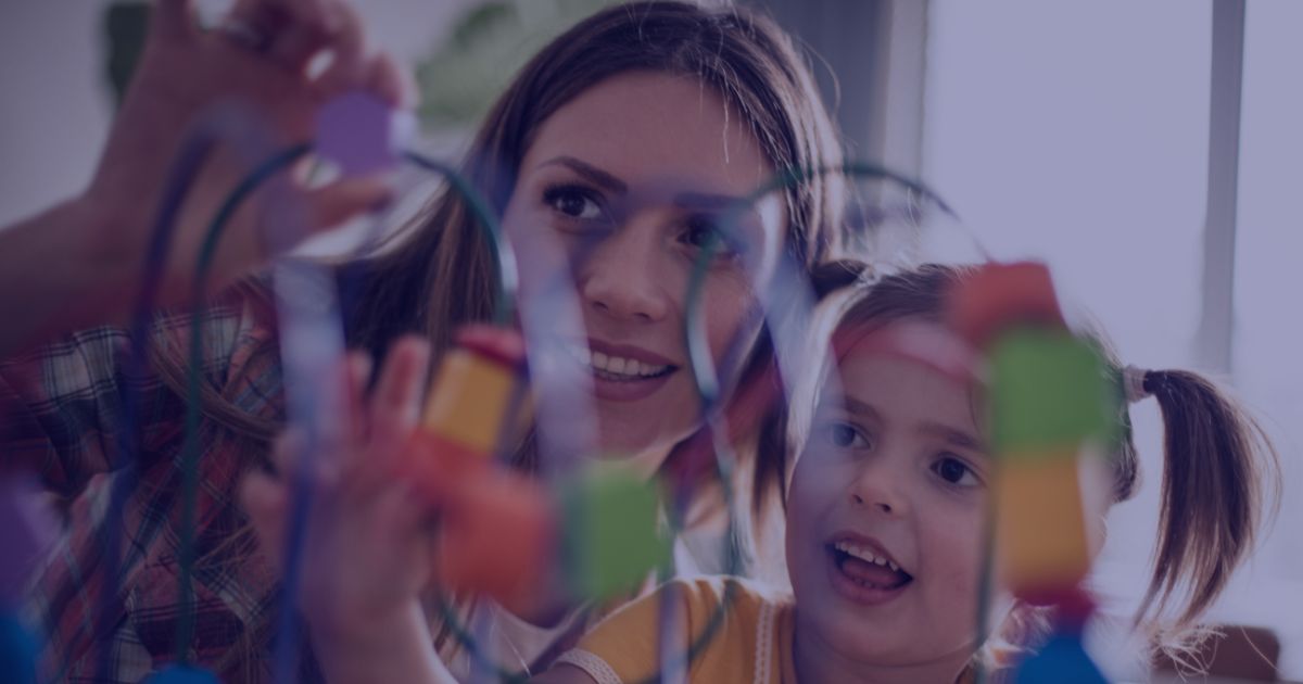 A person and child looking through colorful building blocks or educational toys together, viewed through a creative, kaleidoscopic filter effect.