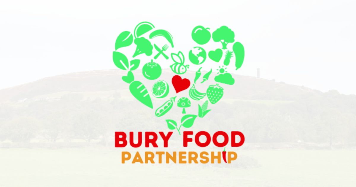 The Bury Food Partnership logo positioned over a faded image of a hill with a tall tower on top