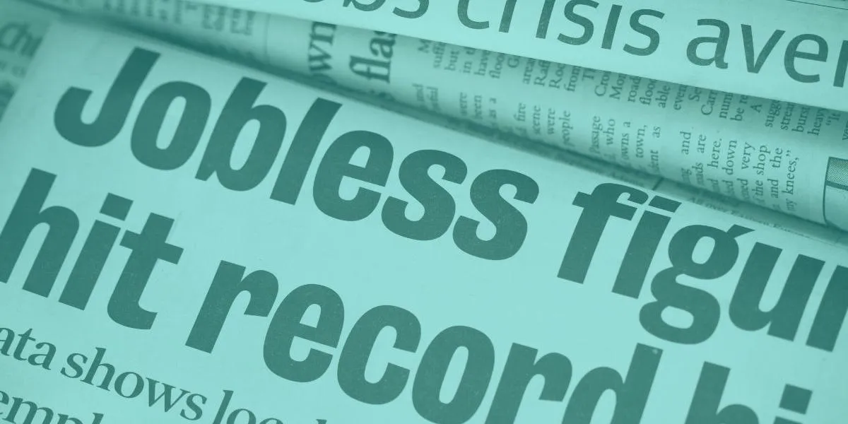 newspaper with a headline reading jobless figures hit record high
