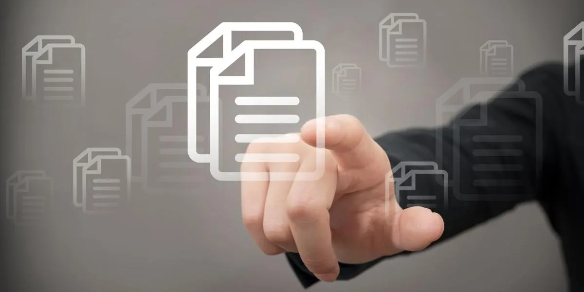 a hand reaches out to touch a large graphic of a document