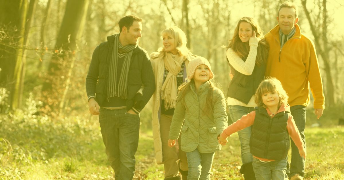 a multi generational family talking a walk in the park, with a transparent yellow overlay