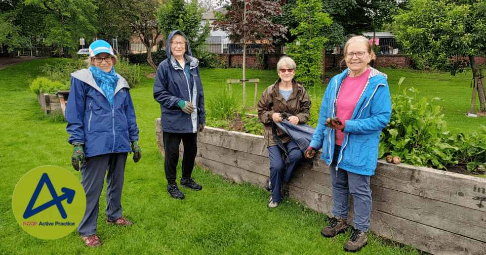 a group of women looking proud, surrounded by plants in a park