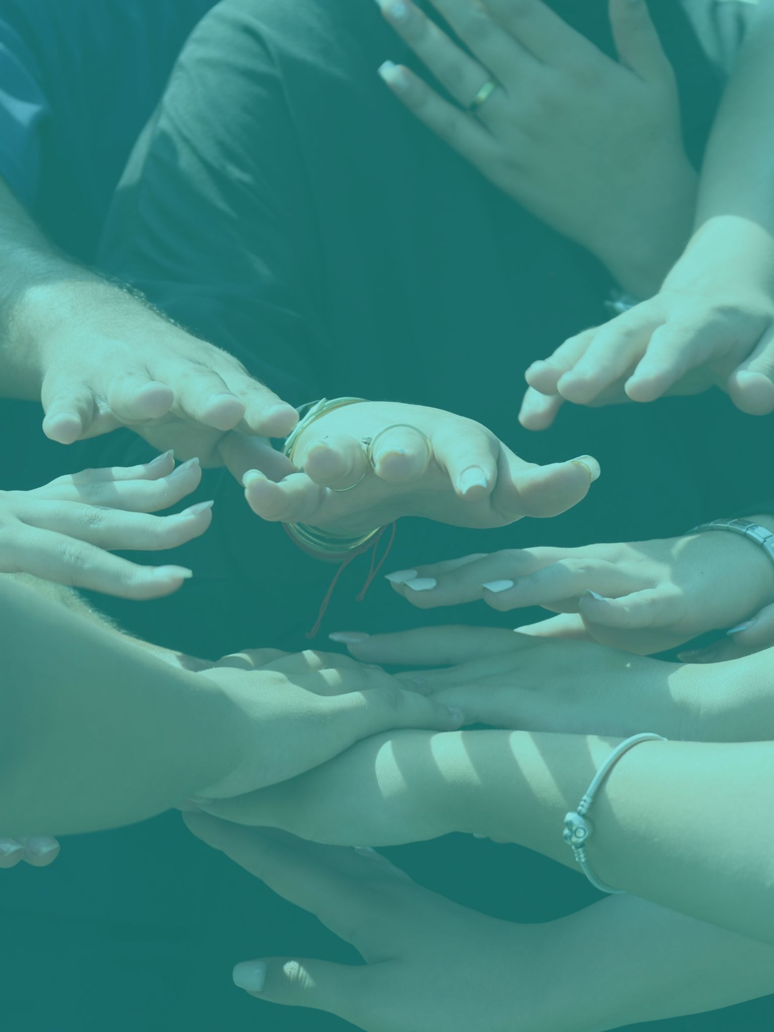 a number of hands come together to symbolize team work and partnership working 