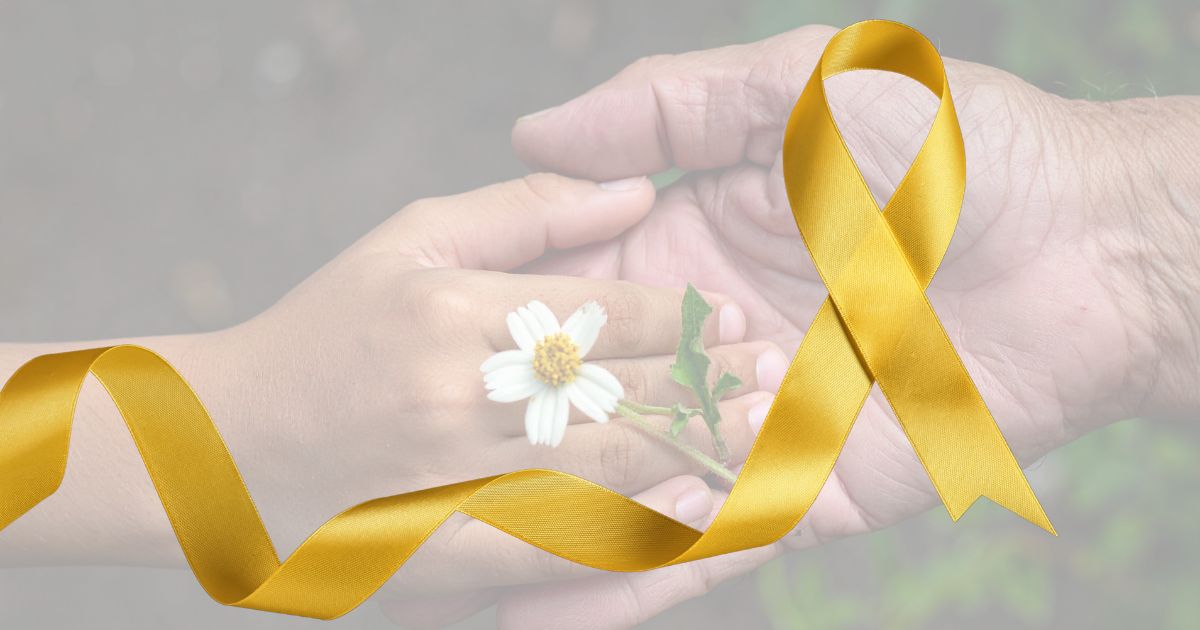 a young hand reaches out to the hand of an older person, with a golden ribbon in shot, increasing awareness of suicide