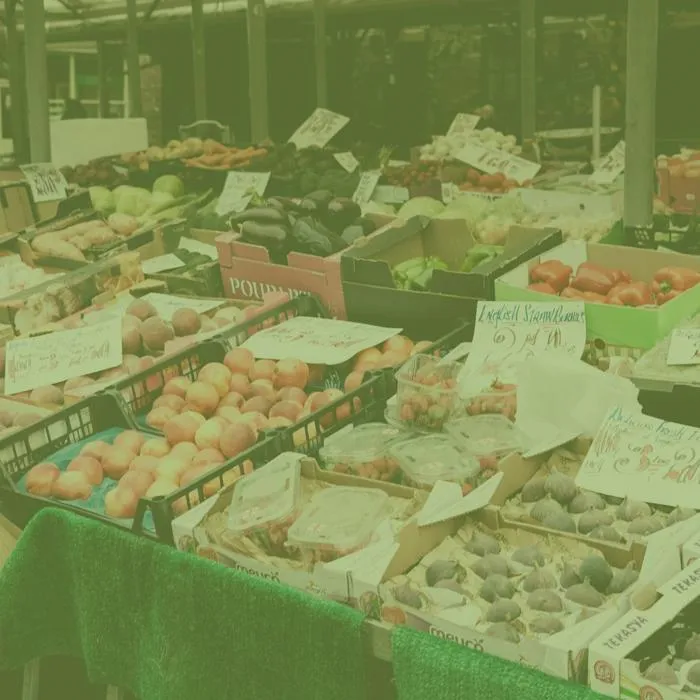 a market stall with boxes of fruit and veg on display